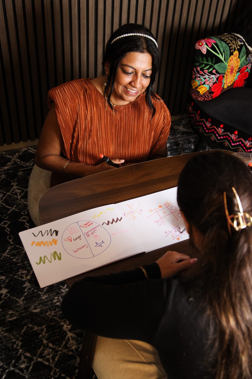WGT-how-we-work-together-therapy-gold-coast Therapist and client working together on a worksheet at Wild Ground Therapy, Gold Coast